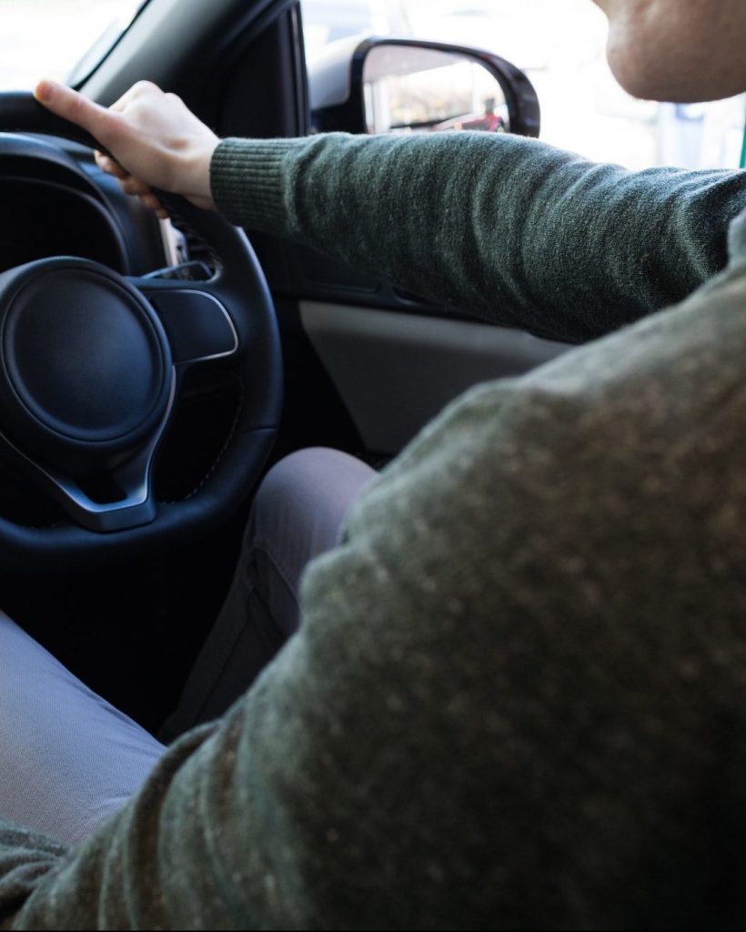 man-using-smartphone-while-driving-car.jpg